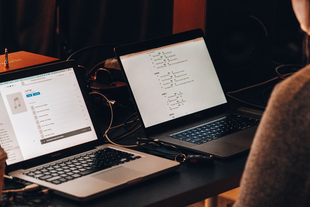 Team working with audio production on laptops in modern studio